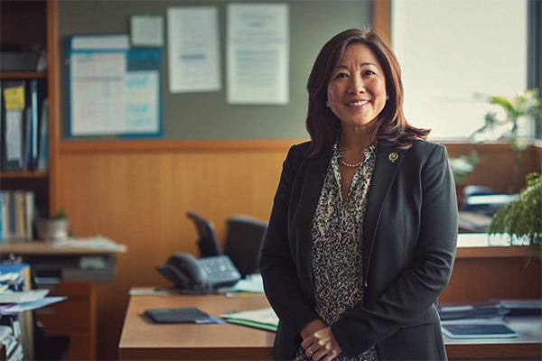 Head of School in front of desk